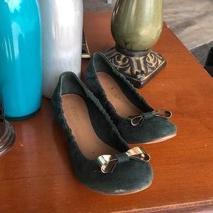 Green flats with gold bow